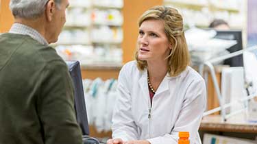 Male customer speaking to pharmacist at the counter