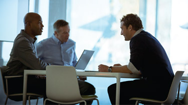 Three men having meeting in a conference room