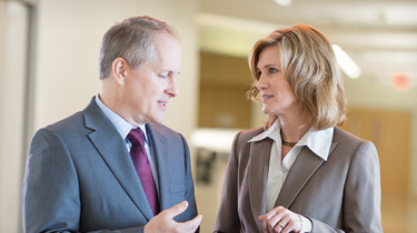 two professionals meeting in a hallway