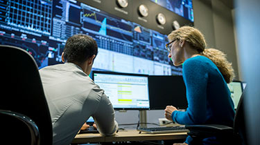 man and women looking at screen